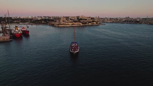 Aerial view of people jumping off the boat in La Valletta, Malta.