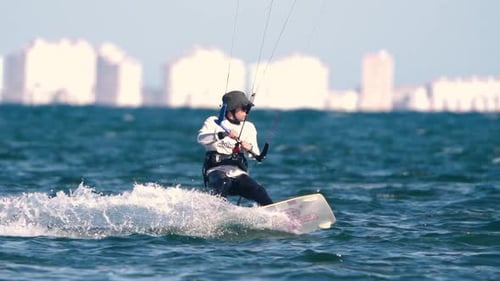 Sportsman practicing kite surf sport at the beach on a windy day at the Spanish coasts