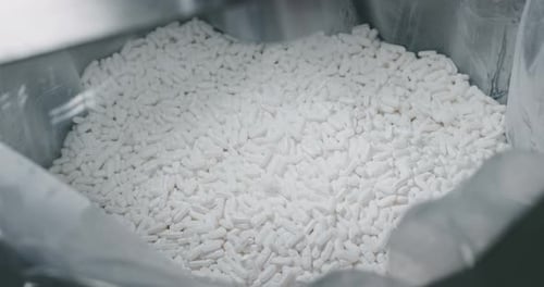 Close up of production of medical pills on automatic lines in a pharmaceutical factory. Concept of