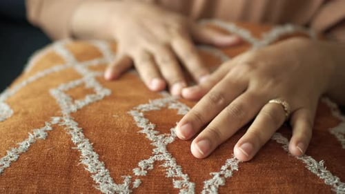Close Up of Women Hand on Colorful Pillow