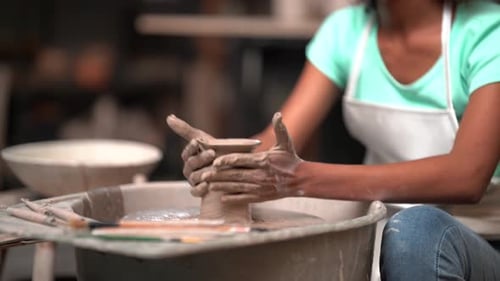People Creating Pottery in Studio. Female artisan creating handmade ceramics in pottery workshop