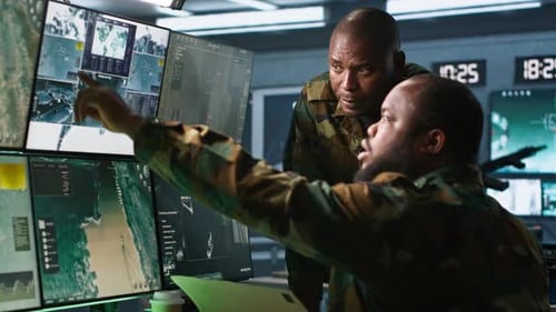 Men Reviewing Technology in Bright Control Room