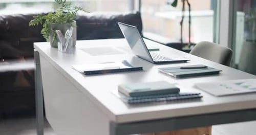 Empty office, desk and laptop with documents, graphs and interior design for financial consulting