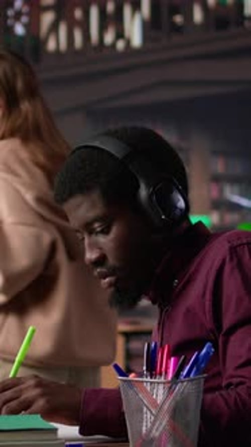 Vertical Video Black Guy Using Study Music to Help with Deep Focus for Academic Success