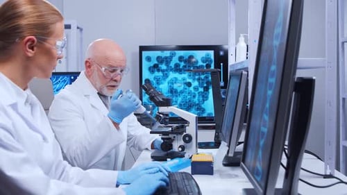 Scientists Working with Microscope in Modern Lab