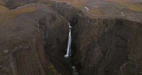 Litlanesfoss Waterfall In Iceland During Snowfall - Aerial Drone Shot