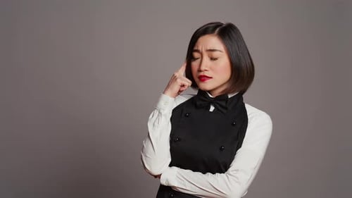 Asian Waitress Thinking About New Menu Ideas for Restaurant