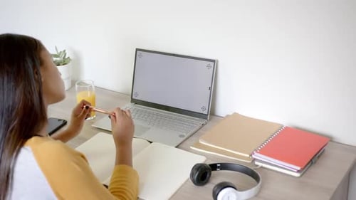 Woman Studying at Desk with Laptop and Chroma Screen