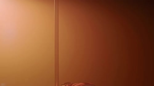 Female Pole Dancer Moving Seductively on Floor