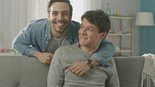 Affectionate Couple Embrace and Smile On Camera