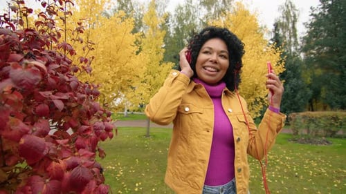 Woman Listening to Music and Dancing Outdoors