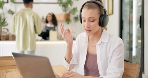 Headphones, laptop and woman on virtual meeting in coffee shop for online webinar