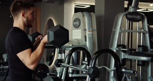 Muscular Man Lifting Weights in Sport Club Screaming Athlete Barbell Exercise at Dark Gym Strong