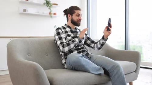 Man Video Calling on Smartphone at Home