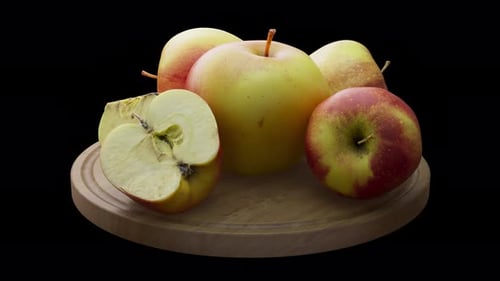 Rotating Red and Green Apples on Wooden Board