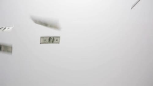 Falling Dollar Bills on White Background