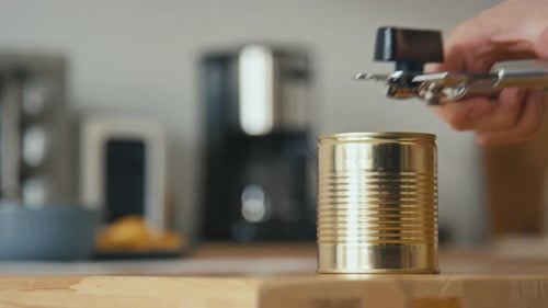 Hands Open Food Can with Can Opener