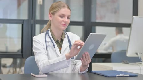 Woman Doctor Using Tablet in Hospital Office
