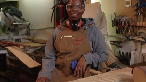 Portrait of African American Female Carpenter in Workshop