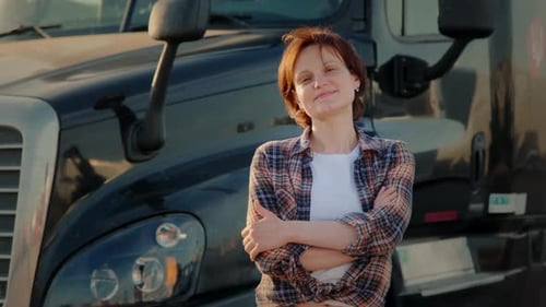 Woman Smiling in Front of Black Semi Truck
