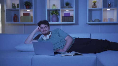 Male student remembering happy memories of night at home and laughing.