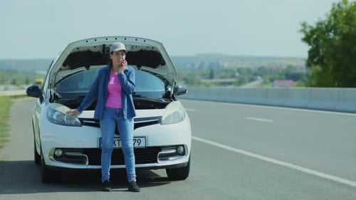 Woman with Smartphone Calls for Car Service After Vehicle Breakdown on the Road