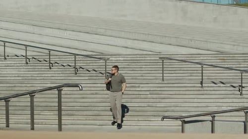 Man Walking Down Stairs in Urban Setting