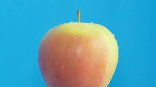 Close Up of Fresh Apple on Blue Background