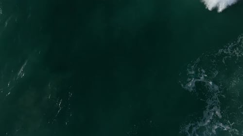 Aerial View Of A Powerful Ocean Wave With White Foam.