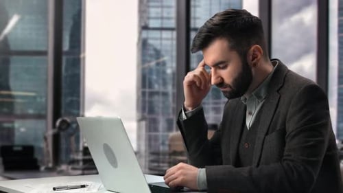 Tired Fashion Business Man Use Laptop Overworked Suffering Headache at Modern Office Desk Workplace