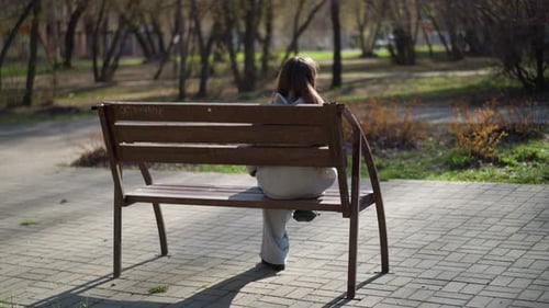 Lady Sitting Quietly Woman Resting at Park Young Female Seated Peacefully in Park Female Individual