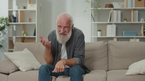 Senior Man Speaking on a Couch