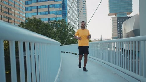Man Running on a Bridge in the City