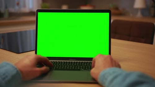 Shooting of Unrecognizable Man's Hands Typing on Keyboard of Laptop with Green Screen While Sitting