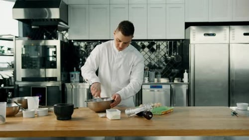 Baker Mixing Ingredients in Commercial Kitchen