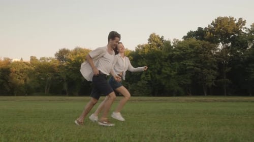 Couple Running Through Park