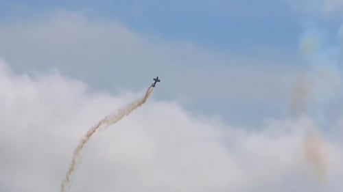 Stunning Aerobatic Airplane Smoke Trail Against Cloudy Sky