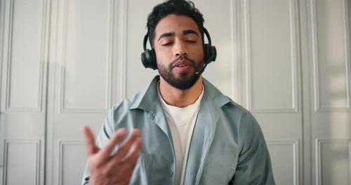 Man Wearing Headset Speaking During Online Video Call