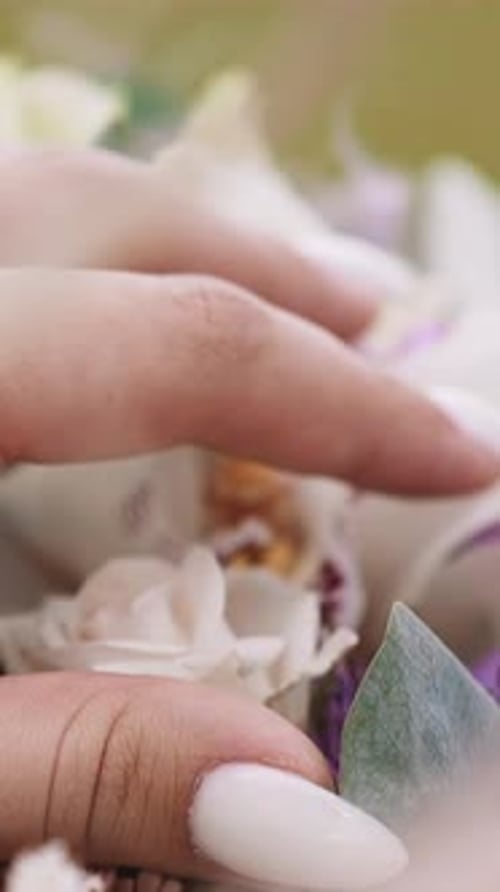 Woman Touches Fresh Flowers Bouquet on Store Display