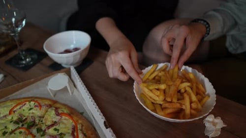 Pizza and French Fries on Tabletop