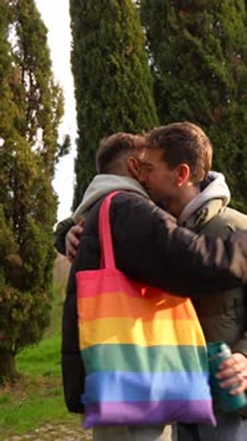 Young caucasian gay couple showing affection in a park