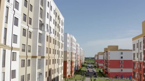 From Above Drone View Flying Over Street with New Colorful Residential Buildings in Modern Urban