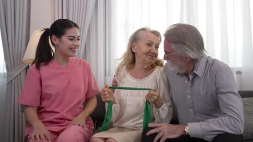 Physical Therapist Helping Senior Woman with Exercise