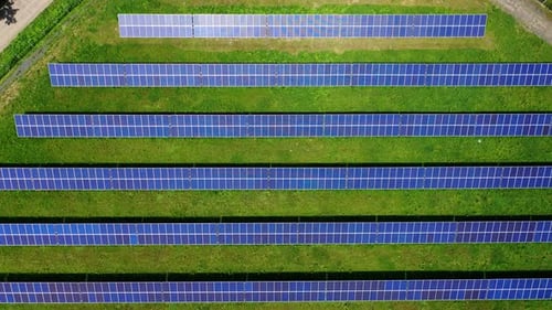 Innovative solar panels in rows on field. Blue sunny batteries receive ecological energy from sun.