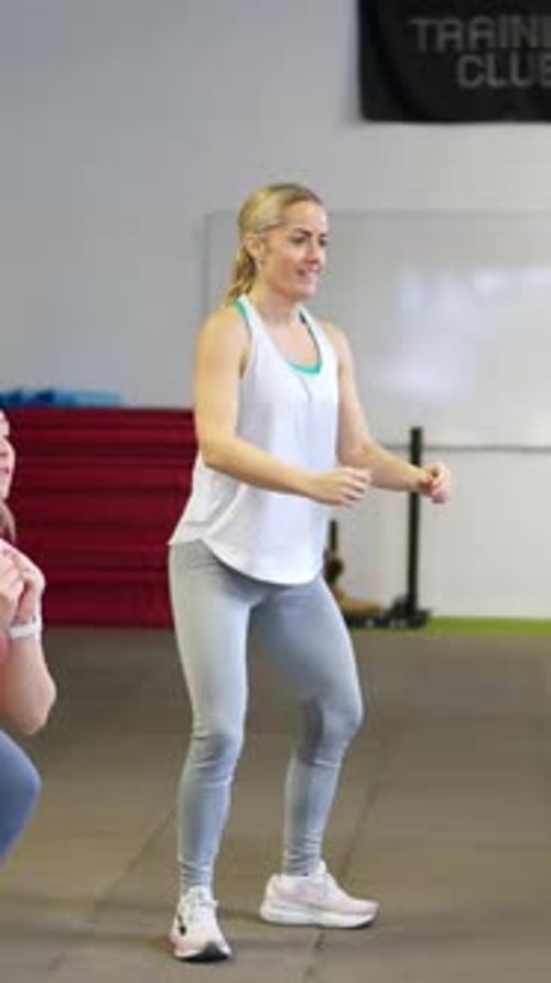 Blonde Woman Performing Bodyweight Squats at the Gym