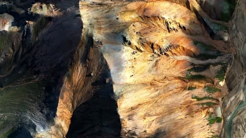 Dramatic Aerial View of Golden Mountain Ridges and Deep Canyons