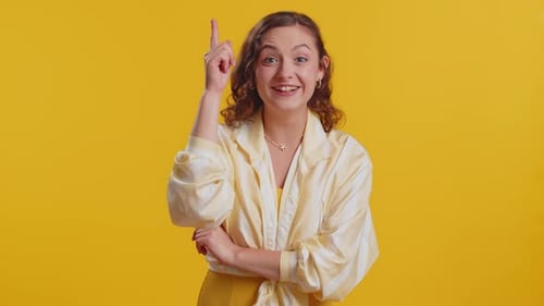Woman Has Idea, Thumbs Up on Yellow Background