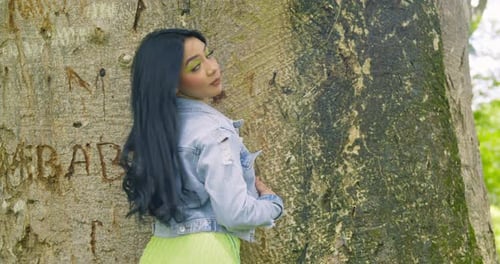Latina girl wearing a jacket turns and reveals her short green dress Latina girl wearing a jacket turns and reveals her short green dress
