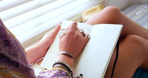 Planning, relax and a woman writing in a book for goals, creativity or reflection