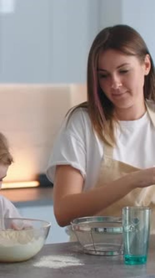 Woman and Girl Baking Together in Home Kitchen